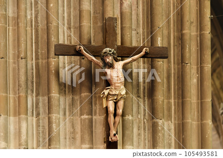 A statue of Jesus hanging from a cross 105493581