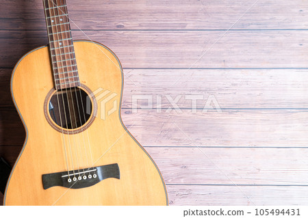 Acoustic guitar on rustic wooden background. 105494431