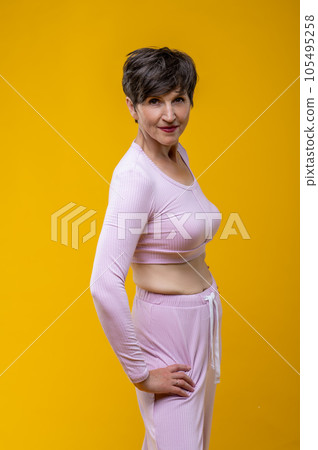 Short-haired senior smiling woman in pink Short-haired senior smiling woman in pink 105495258