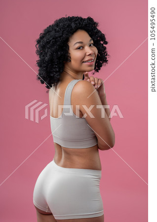 Dark-haired woman in grey lingerie looking happy Dark-haired woman in grey lingerie looking happy 105495490