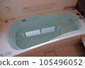 A white bathtub in a typical Japanese house filled to the brim with hot water 105496052