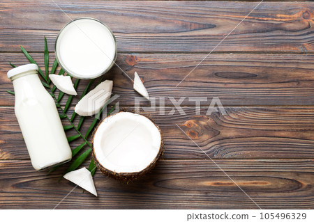 coconut products on white wooden table background. Dairy free milk substitute drink, Flat lay healthy eating 105496329