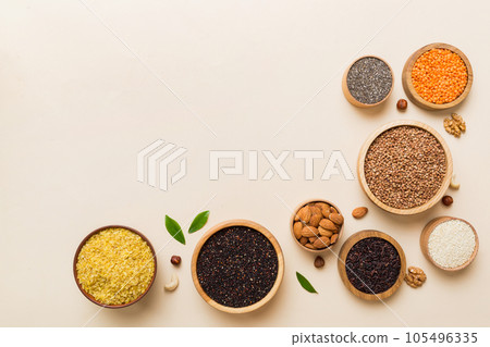 Various superfoods in smal bowl on colored background. Superfood as rice, chia, quinoa, lentils, nuts, sesame seeds, almonds. top view copy space Various superfoods in smal bowl on colored background. Superfood as rice, chia, quinoa, lentils, nuts, sesame seeds, almonds. top view copy space 105496335