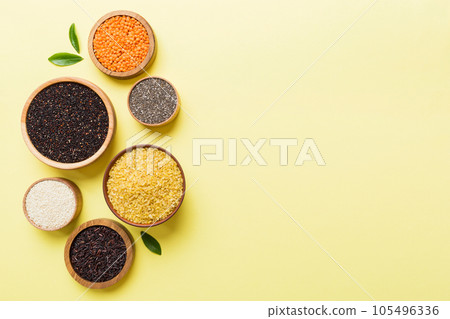 Various superfoods in smal bowl on colored background. Superfood as rice, chia, quinoa, lentils, nuts, sesame seeds, almonds. top view copy space Various superfoods in smal bowl on colored background. Superfood as rice, chia, quinoa, lentils, nuts, sesame seeds, almonds. top view copy space 105496336