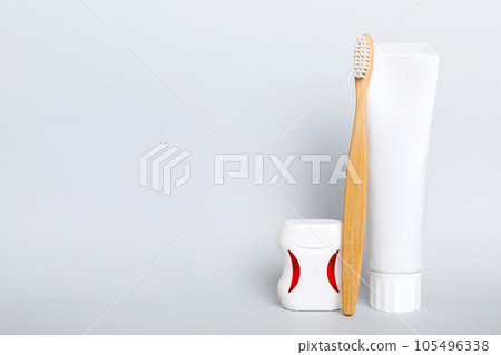 toothpaste and toothbrush top view with copy space on colored background. Flat lay. Dental hygiene. Oral care products on light background. Body care concept 105496338