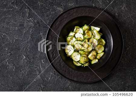 Sunomono, Japanese Cucumber Salad in a black bowl 105496620