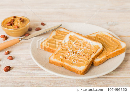 Peanut butter sandwiches or toasts on light table background.Breakfast. Vegetarian food. American cuisine top view vith copy space Peanut butter sandwiches or toasts on light table background.Breakfast. Vegetarian food. American cuisine top view vith copy space 105496860