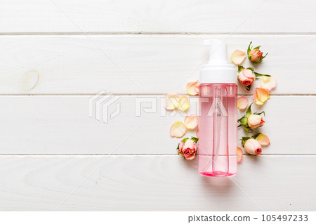 Fancy healthcare bottles for serum, micellar, tonic, toner, lotion, water and cream with rose flower. Natural oranic spa cosmetics concept. Mockup, template, Top view Fancy healthcare bottles for serum, micellar, tonic, toner, lotion, water and cream with rose flower. Natural oranic spa cosmetics concept. Mockup, template, Top view 105497233