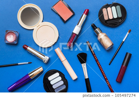 Professional makeup tools. Top view. Flat lay. Beauty, decorative cosmetics. Makeup brushes set and color eyeshadow palette on table background. Minimalistic style 105497274