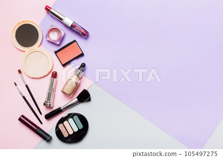 Professional makeup tools. Top view. Flat lay. Beauty, decorative cosmetics. Makeup brushes set and color eyeshadow palette on table background. Minimalistic style Professional makeup tools. Top view. Flat lay. Beauty, decorative cosmetics. Makeup brushes set and color eyeshadow palette on table background. Minimalistic style 105497275