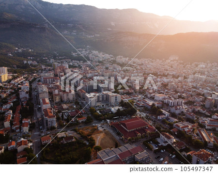 Aerial view of modern and old town cityscape of Budva, Mongenegro on Adriatic Sea coast and Saint Nikhola's island on background on summer sunny day. Center of tourism and popular sea resort. 105497347