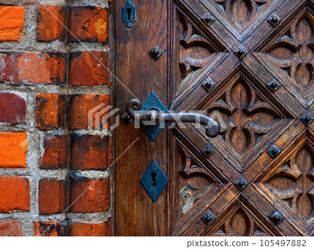 vintage handle on the background of a wooden door vintage handle on the background of a wooden door 105497882