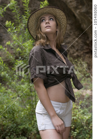 woman in country clothes walking through a forest in nature 105498060
