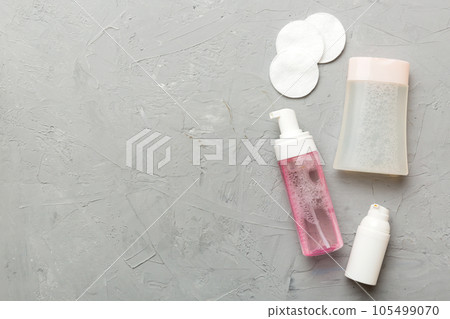 Micellar cleansing water and discs to remove cosmetics and cleanse the skin on colored background. Copy space top view 105499070