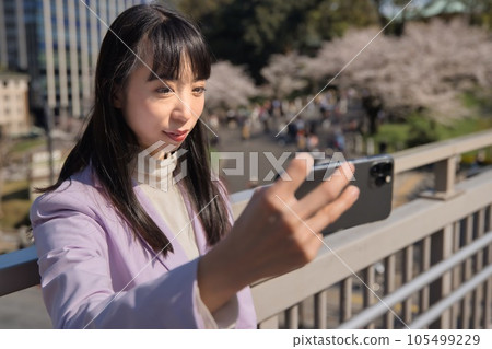 Business woman taking selfie with smartphone Business woman taking selfie with smartphone 105499229