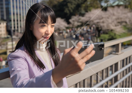 Business woman taking selfie with smartphone Business woman taking selfie with smartphone 105499230