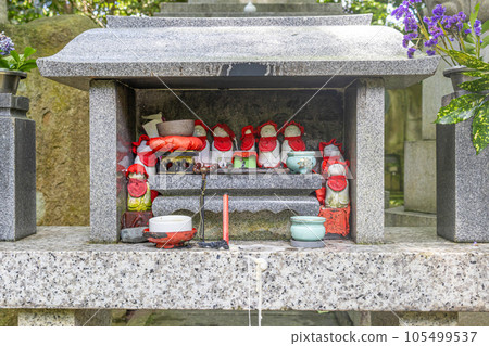 Collection of stone statues (public art) of Ojizou san, protector of children, and offerings. Japan. 105499537