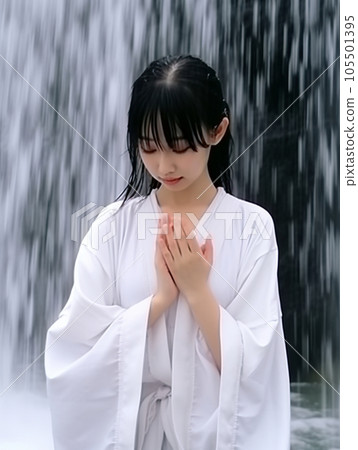 Young woman being hit by a waterfall 105501395