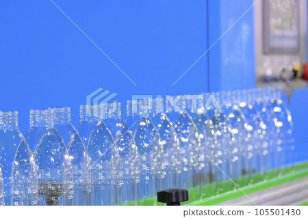The  empty drinking water bottles  on the conveyor belt for filling process. 105501430