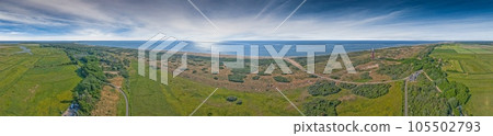 Drone panorama of Ouddorp lighthouse in Holland with surrounding dunes during daytime 105502793