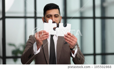 businessman show white jigsaw in hand, business strategy concept businessman show white jigsaw in hand, business strategy concept 105502868