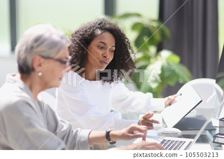 Software development team discussing algorithms on computer screen in office 105503213