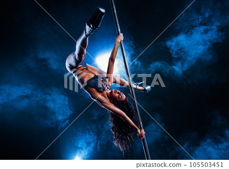 Young woman pole dancing 105503451