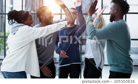 Group of happy colleagues feel motivated giving high five Group of happy colleagues feel motivated giving high five 105503638