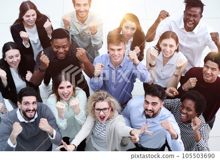 overhead view of businesspeople looking up and waving 105503690
