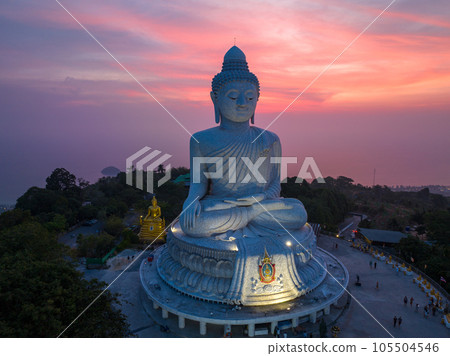 aerial view Phuket big Buddha in beautiful sunset. the sun shines through the clouds impact on ocean surface The beauty of the statue fits perfectly with the charming nature. cloud scape background. 105504546