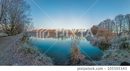 Panoramic image of frozen lake at frosty temperature during sunrise Panoramic image of frozen lake at frosty temperature during sunrise 105505343