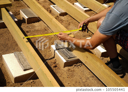 Carpenter, wood and planning with man in workshop for building, manufacturing and creative. Design, industry and woodworker with handyman measuring on workbench for builder, lumber and maintenance 105505441