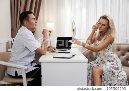 woman talking with doctor about face aesthetic treatment 105506293