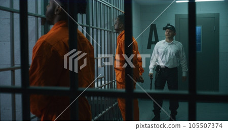 Criminals stand face to cell with hands behind 105507374