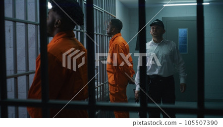 Criminals stand face to cell with hands behind Criminals stand face to cell with hands behind 105507390