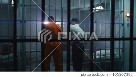 Warden brings guilty prisoner in jail cell Warden brings guilty prisoner in jail cell 105507393