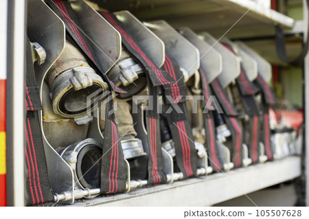 Fire truck equipment. Compartment of the rolled up fire hoses on a fire engine 105507628