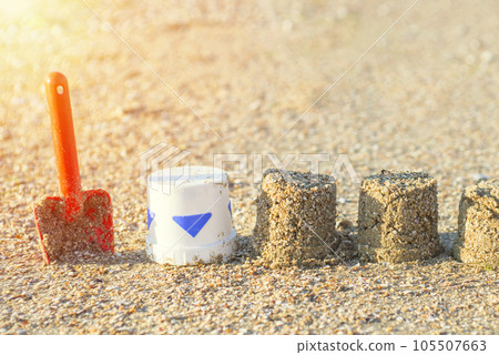 Sand molds and a red baby spatula on the beach. Sand molds and a red baby spatula on the beach. 105507663