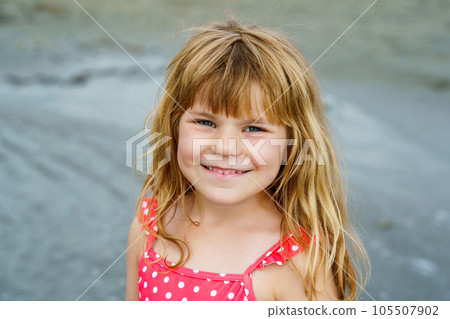 Portrait of Happy Child, Little Preschool Girl in Swimmsuit Running And Jumping In The Waves During Summer Vacation On Exotic Tropical Beach. Family Journey On Ocean Coast. 105507902