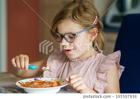 Little preschool girl eating from spoon vegetable potato soup. Healthy food for children. Happy kid at home or nursery. Little preschool girl eating from spoon vegetable potato soup. Healthy food for children. Happy kid at home or nursery. 105507938