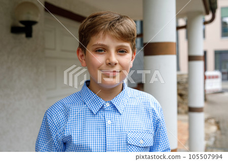 Handsome Teenager Boy Poses Outdoors, Exuding Confidence and Style in a Captivating Portrait. Happy Preteen Child. Handsome Teenager Boy Poses Outdoors, Exuding Confidence and Style in a Captivating Portrait. Happy Preteen Child. 105507994