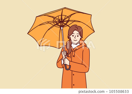 Woman with umbrella is dressed in oilcloth coat so as not to get wet from rain on autumn walk 105508633