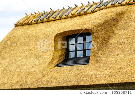 New thatch roof over house with dormer window in Denmark, thatched roof New thatch roof over house with dormer window in Denmark, thatched roof 105508711