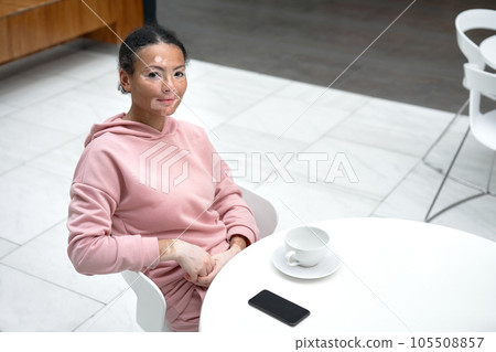 portrait of woman sitting at table in cafe portrait of woman sitting at table in cafe 105508857