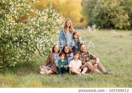 Large friendly family in the summer on the field. Large friendly family in the summer on the field. 105509012