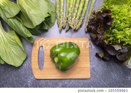 Top View Assortment Of Fresh Organic Vegetables, Green Bell Pepper On Cutting Board On Table. Asparagus Plant, Bok Choy, Red Leaf Lettuce. Healthy Bio Food. Horizontal Plane 105509861
