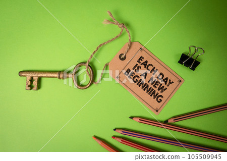 EACH DAY IS A NEW BEGINNING. Cardboard price tag with text on a green background EACH DAY IS A NEW BEGINNING. Cardboard price tag with text on a green background 105509945
