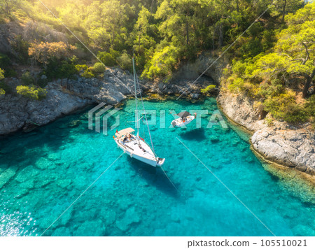 Aerial view of beautiful yacht and sailboat on the sea at sunrise Aerial view of beautiful yacht and sailboat on the sea at sunrise 105510021
