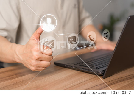 User use a laptop with a virtual screen for apps phones, email, addresses, chat, and message icons. The customer service support hotline contacts us with the people connection technology concept. 105510367