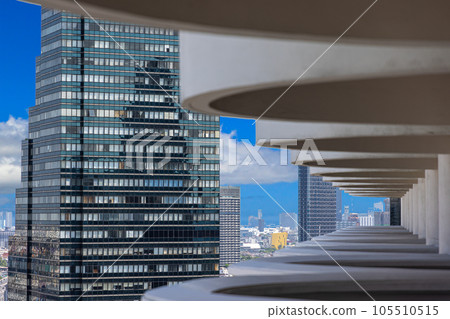 View of high-rise facades through a structure from balconies during the day View of high-rise facades through a structure from balconies during the day 105510515